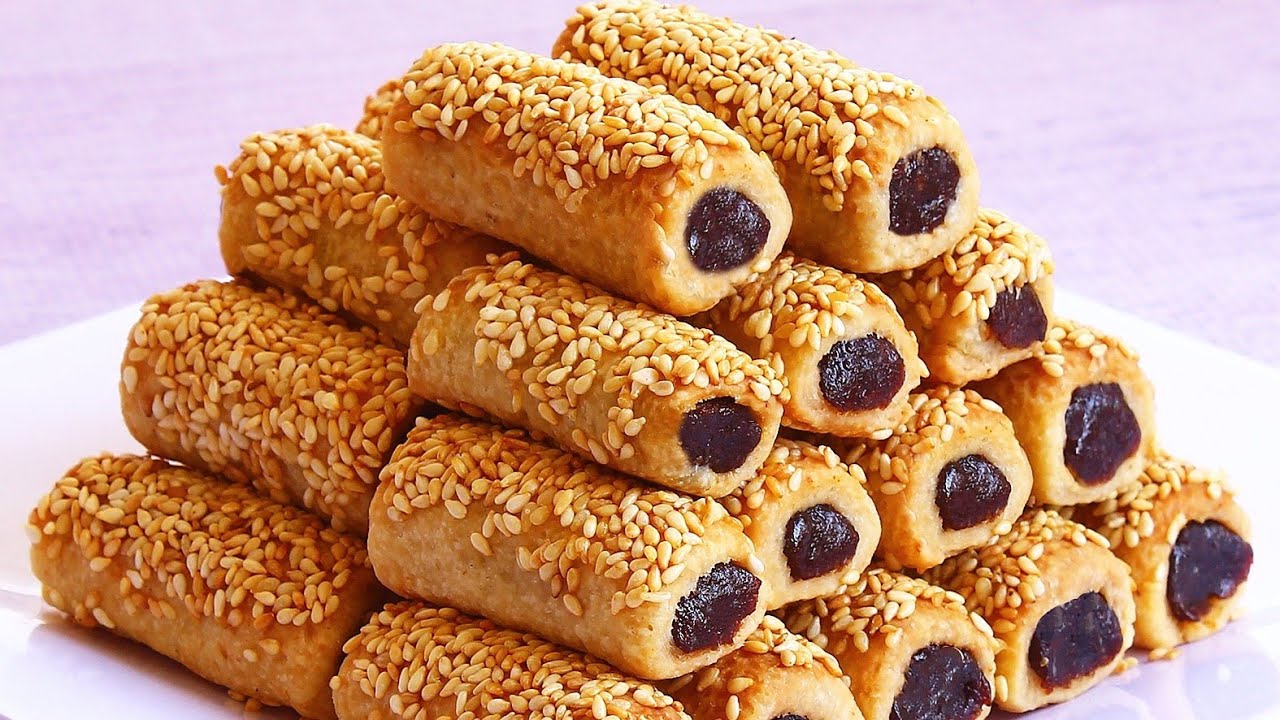 بطعم لا يقاوم.. طريقة عمل أصابع التمر بالسمسم على أصولها بعجينة مظبوطة أحلى من الجاهز 5 بطعم لا يقاوم.. طريقة عمل أصابع التمر بالسمسم على أصولها بعجينة مظبوطة أحلى من الجاهز